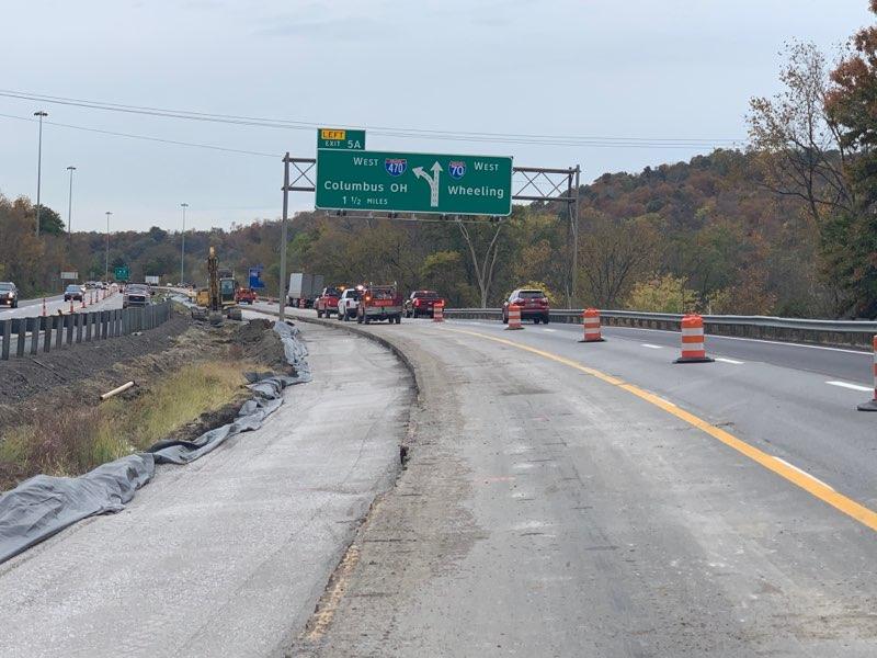 View of the I-70 and I-470 interchange construction zone in Wheeling, West Virginia, featuring the overhead exit sign for Columbus and Wheeling.
