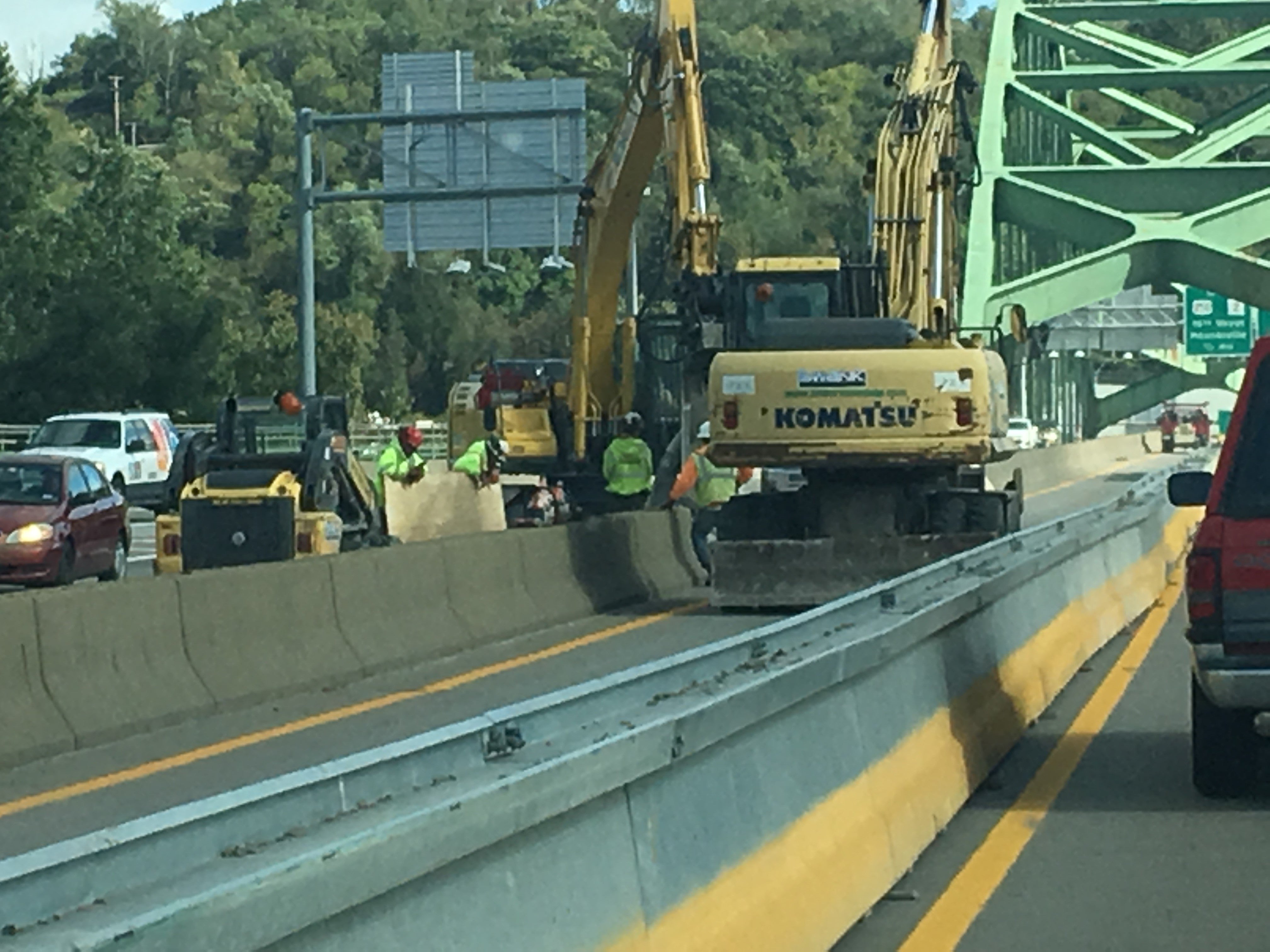 Construction crew and heavy machinery performing rehabilitation work on the I-70 Fort Henry Bridge in Wheeling.